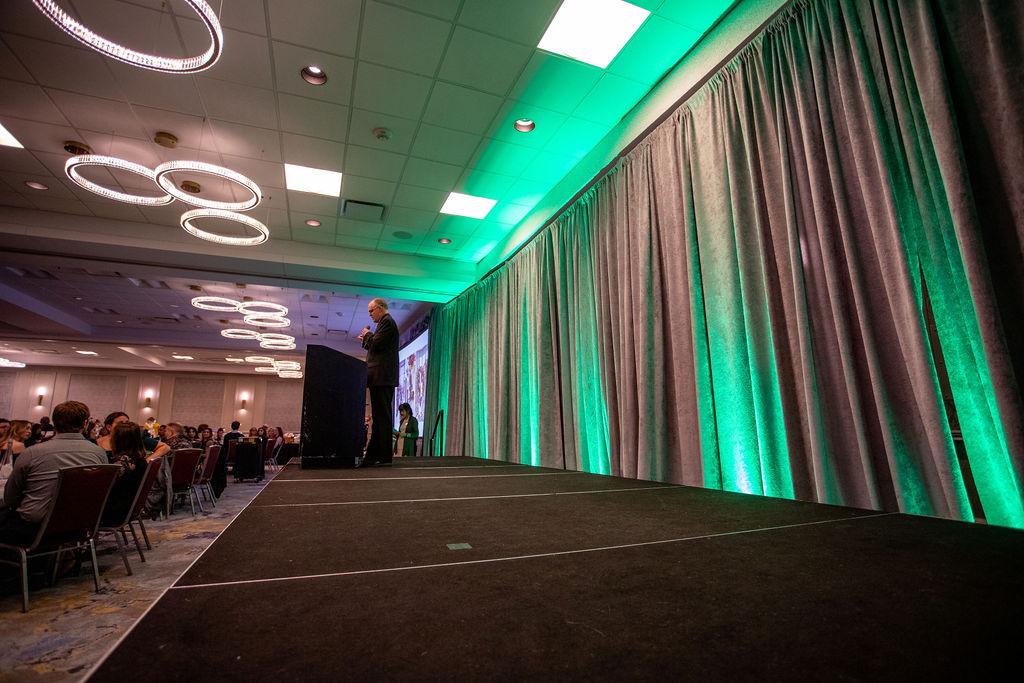 Gala 2025 keynote speaker on stage with green lighting