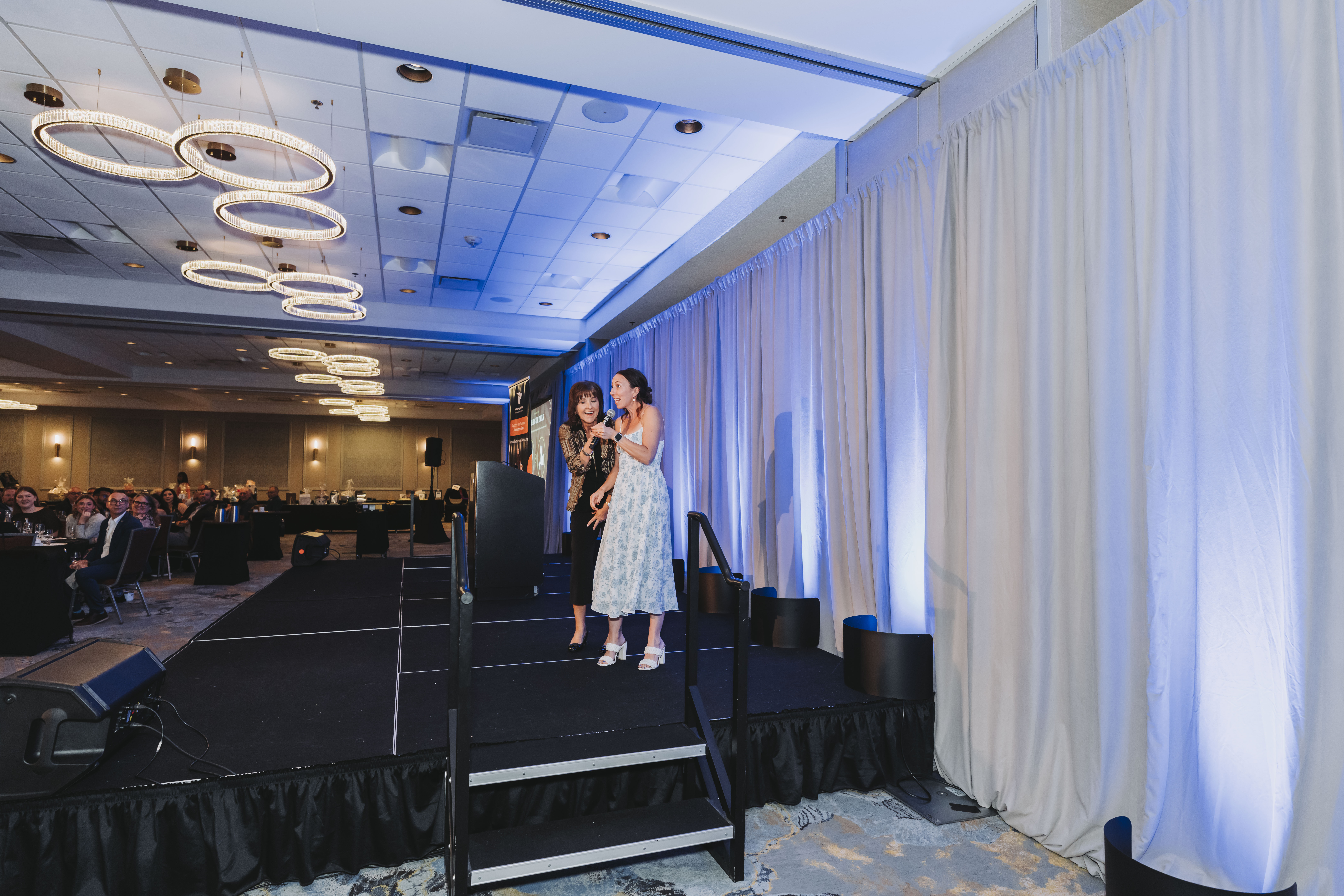 Two guests speaking from the stage during the gala program