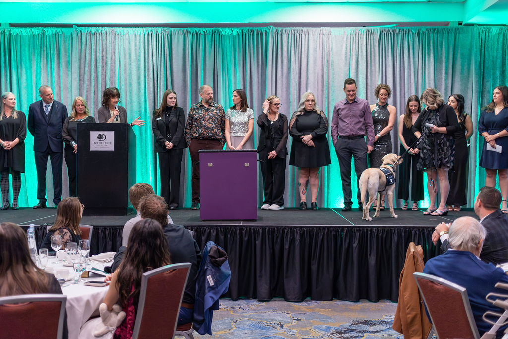 Gala 2025 team and clients on stage