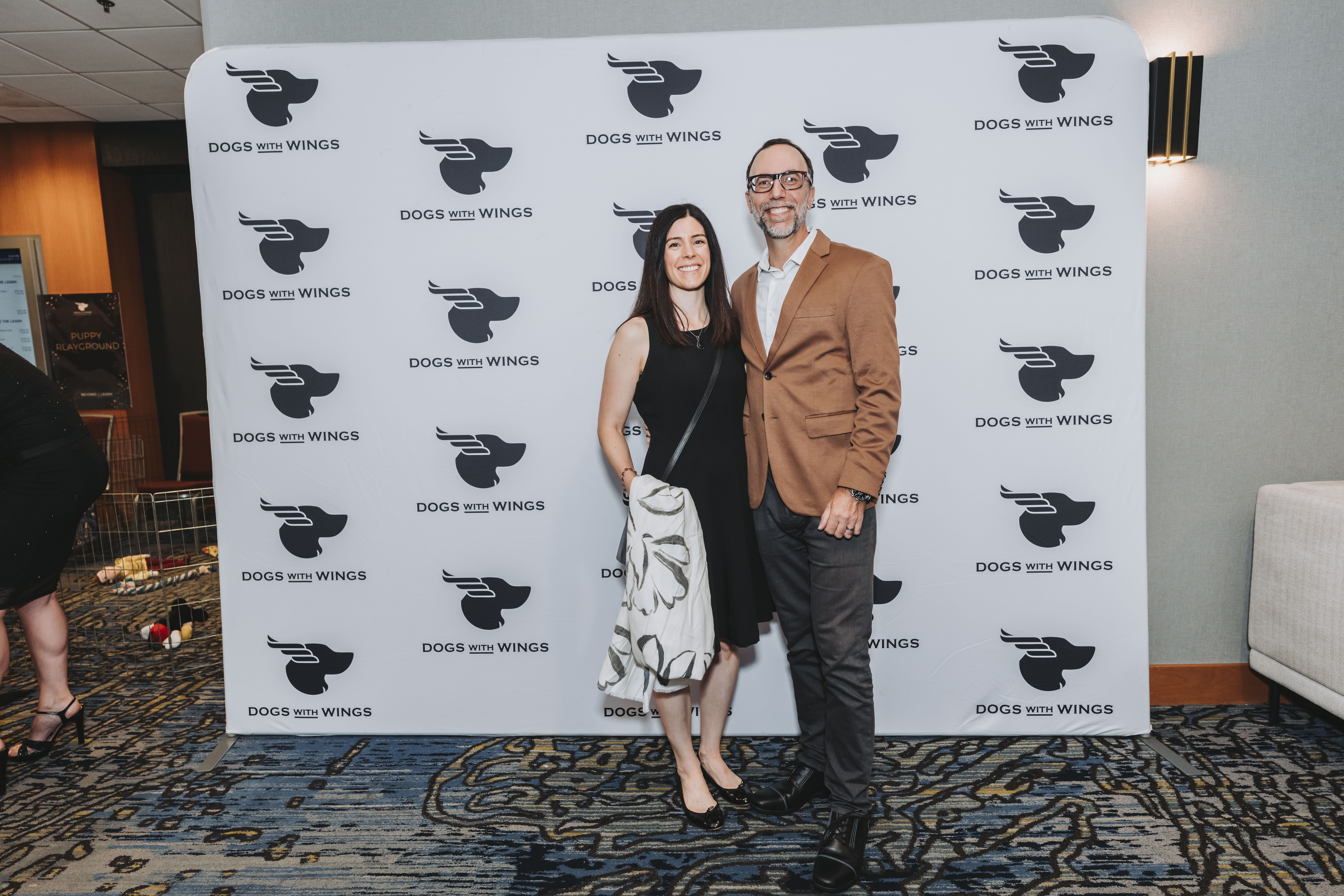A couple dressed up for the gala at the photo wall
