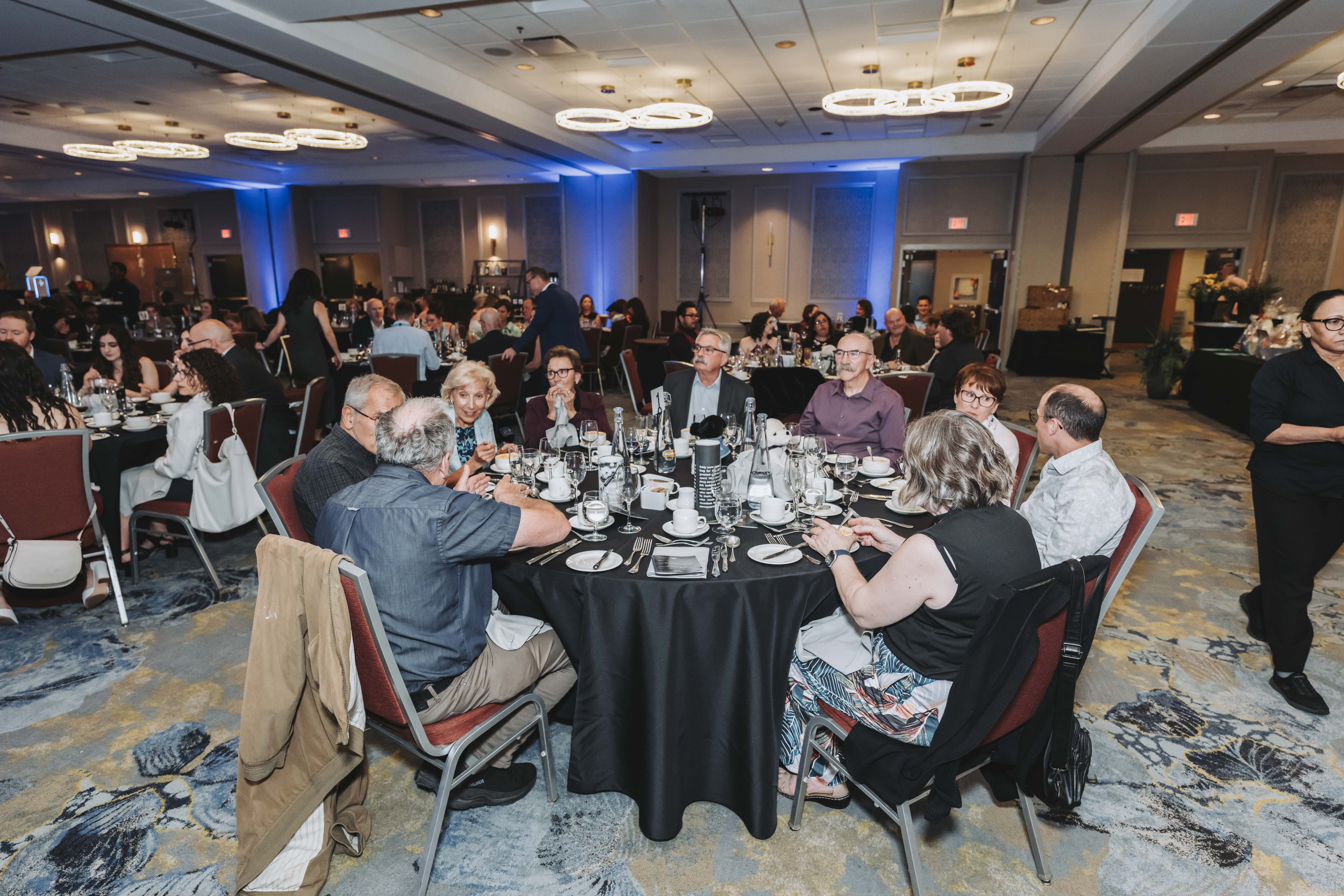 Guests chatting around a gala dinner table