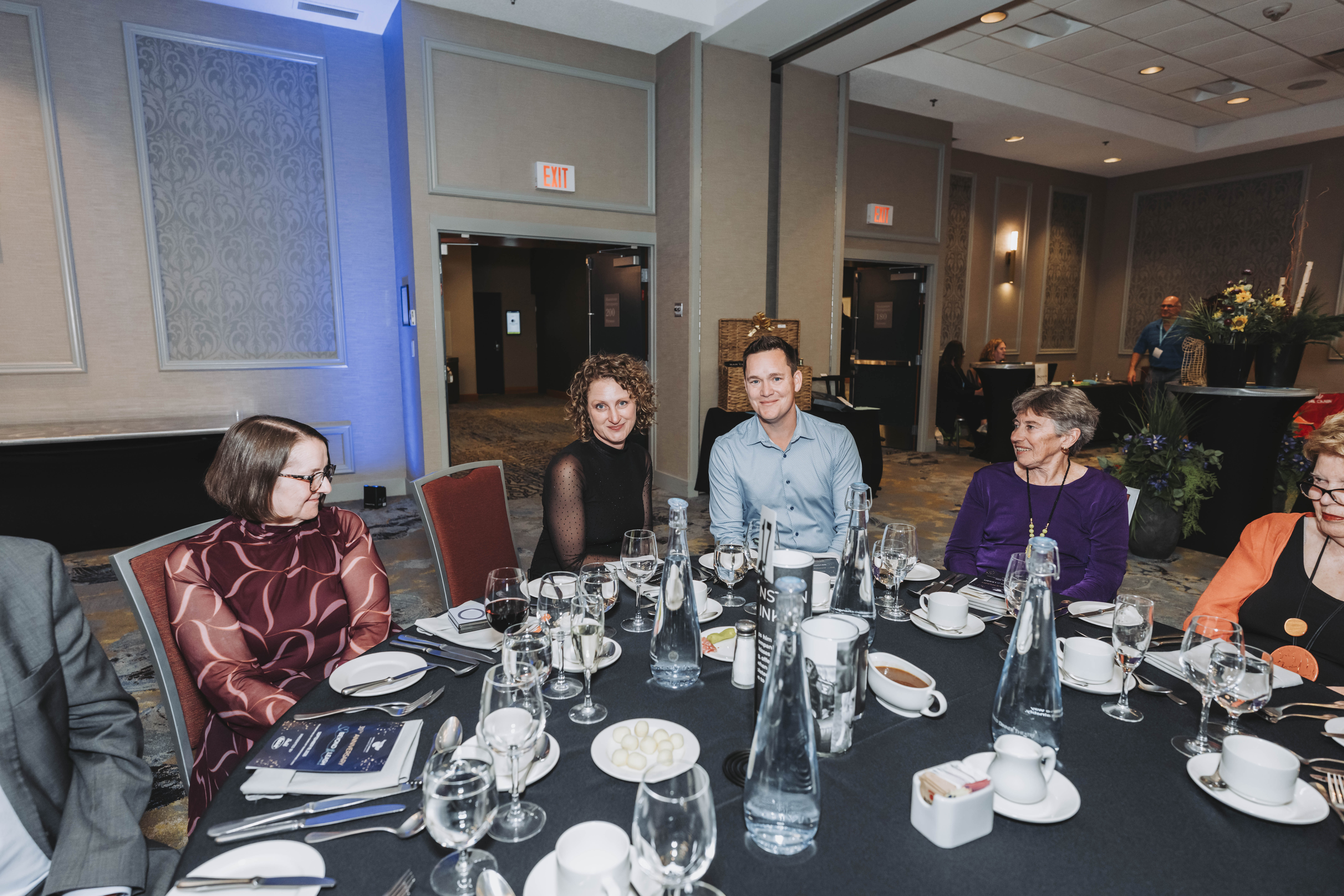 Four guests at their table during the gala dinner