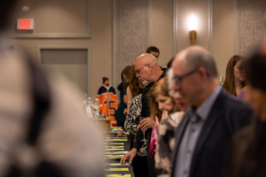 Gala 2025 guests reviewing auction items