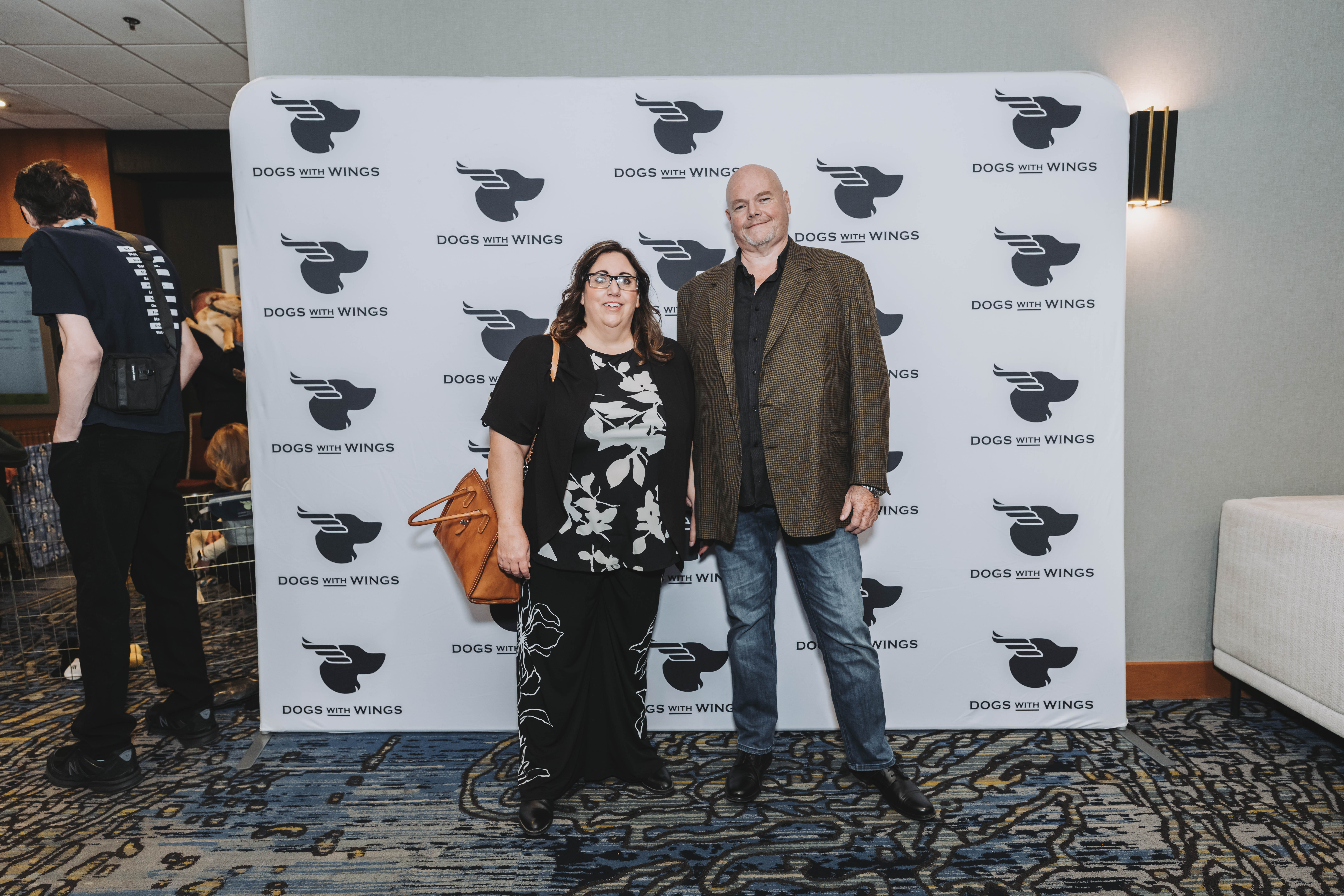 A couple posing at the gala photo wall