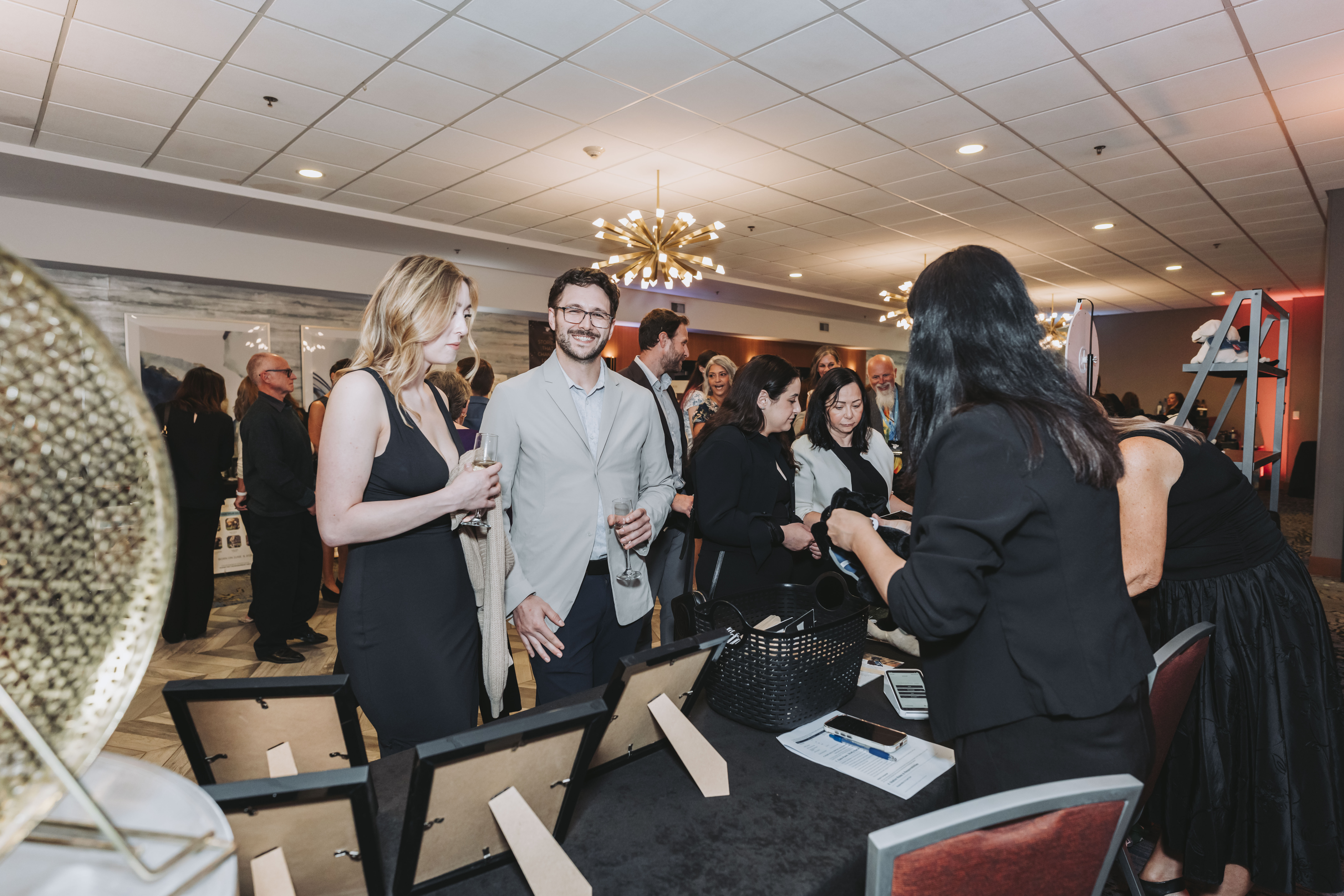 Guests gathering around the Sponsor Our Dogs table