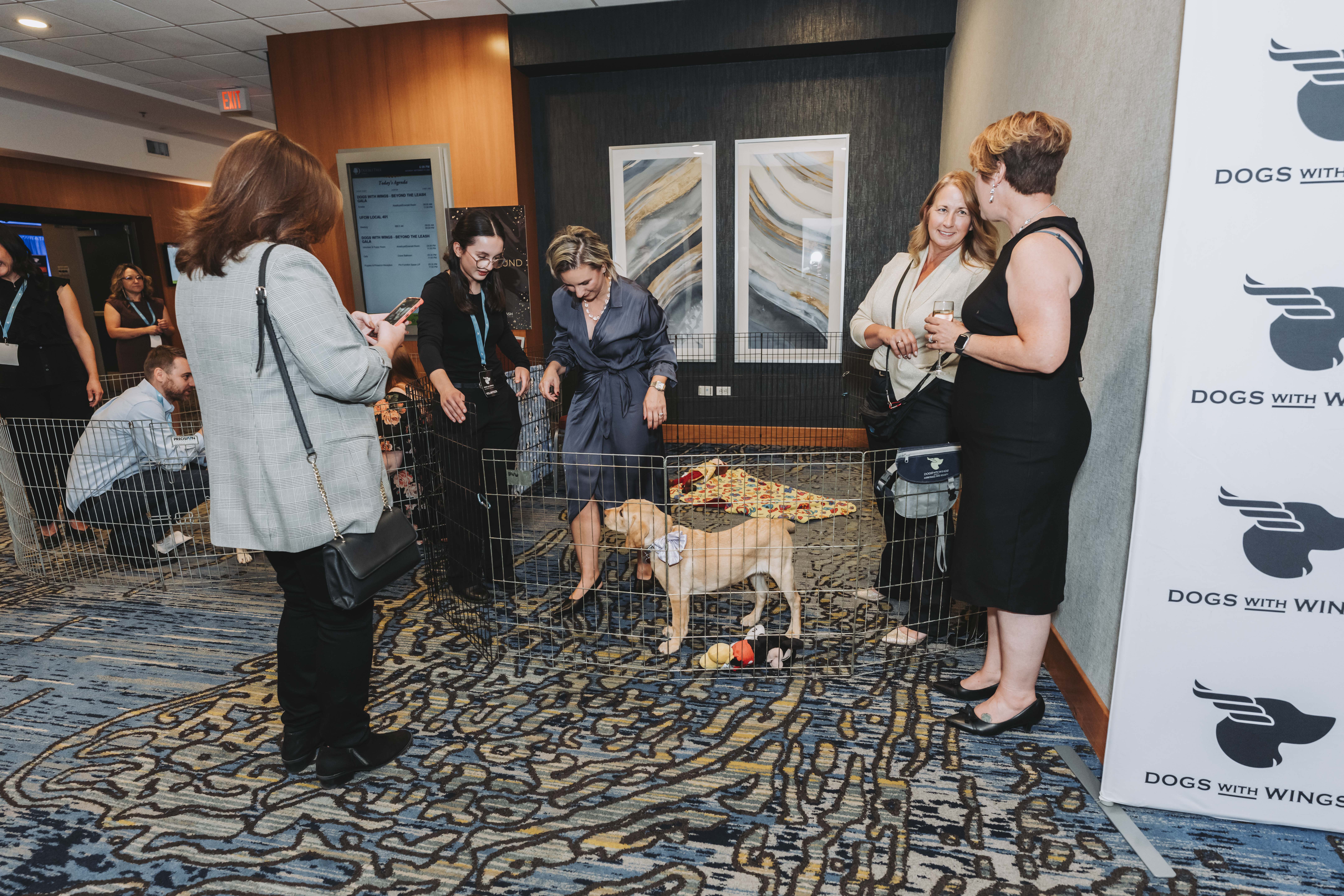 Guests gathering around the puppy playground playpen