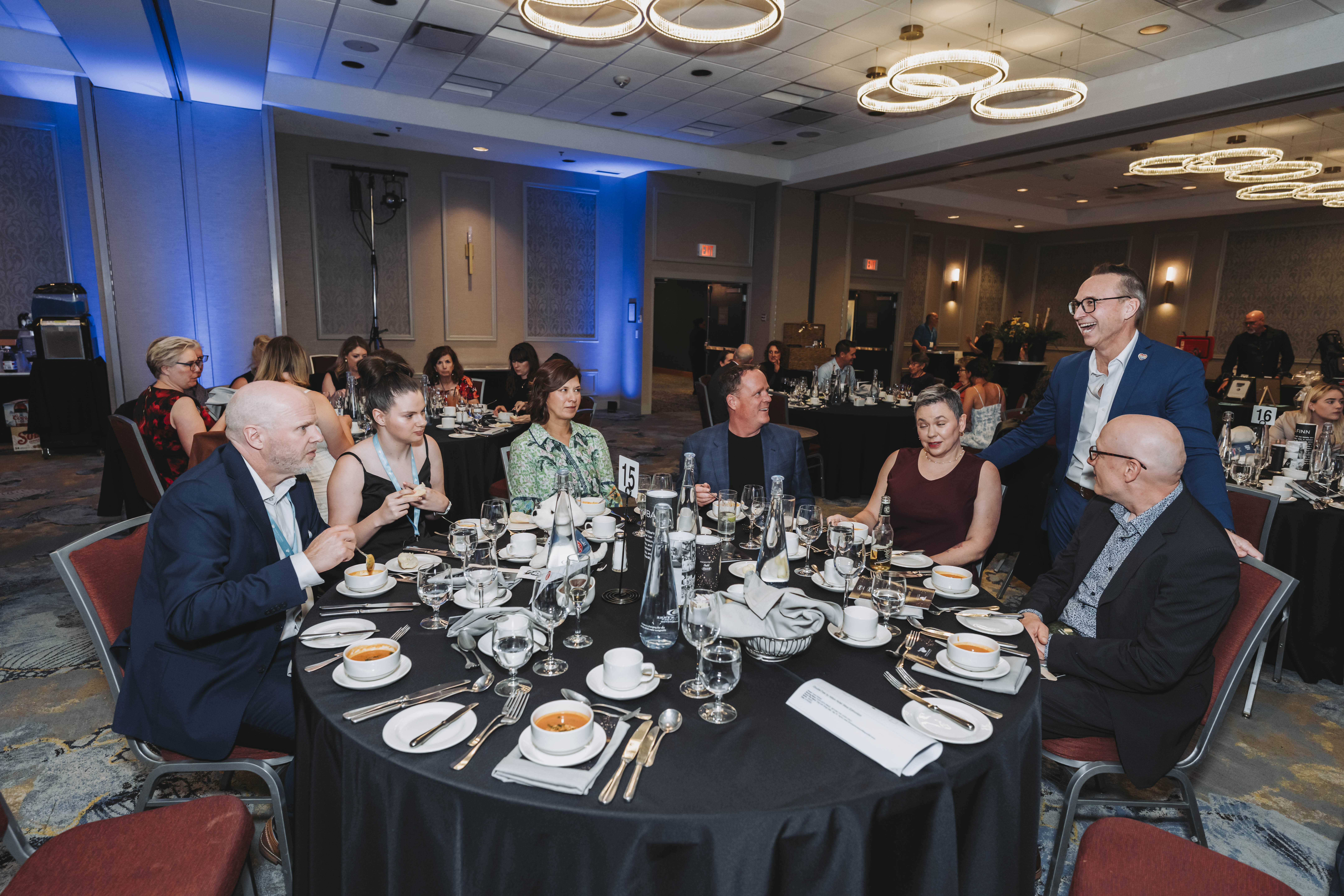 A guest standing to address table fifteen during dinner