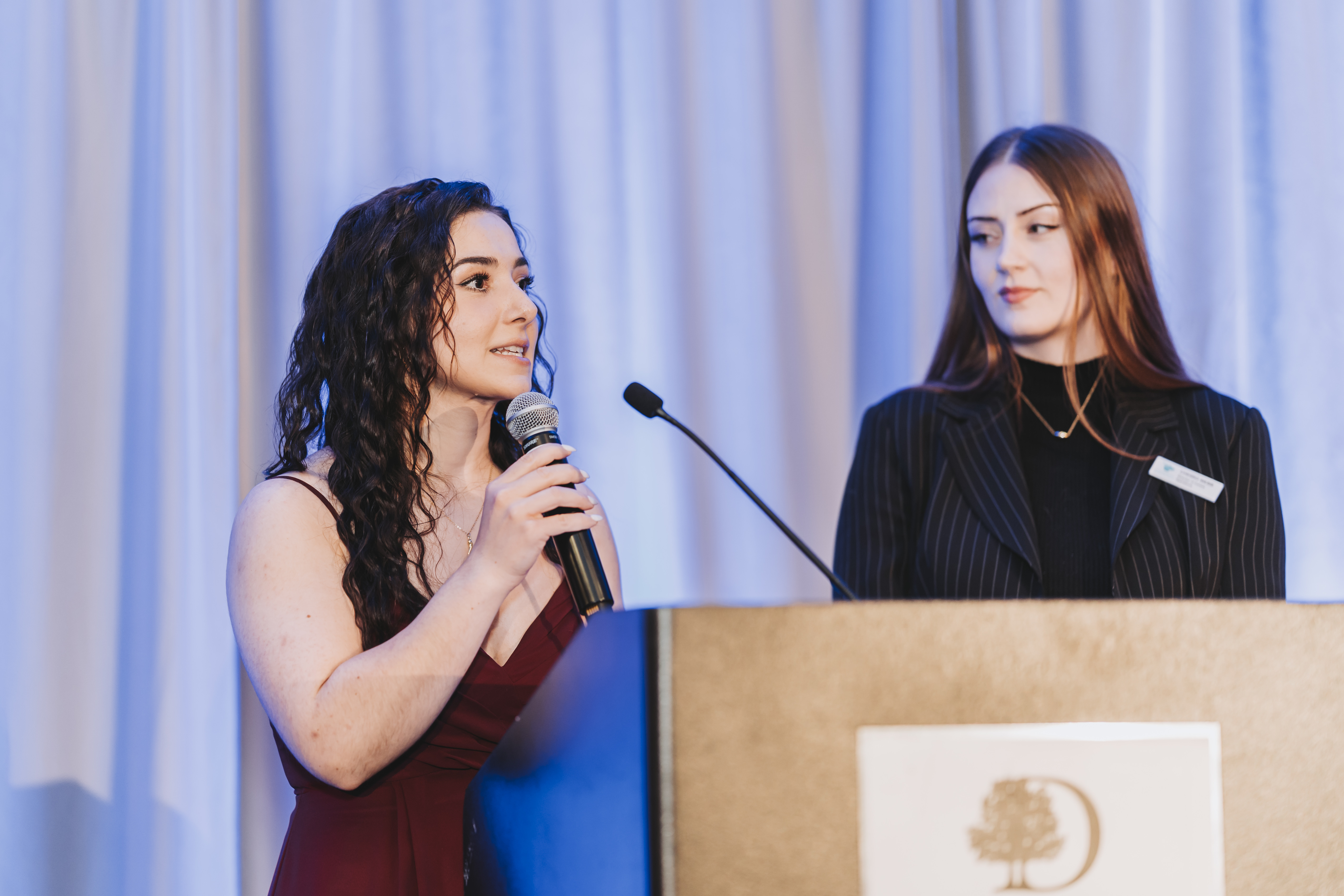Two guests presenting together at the gala lectern