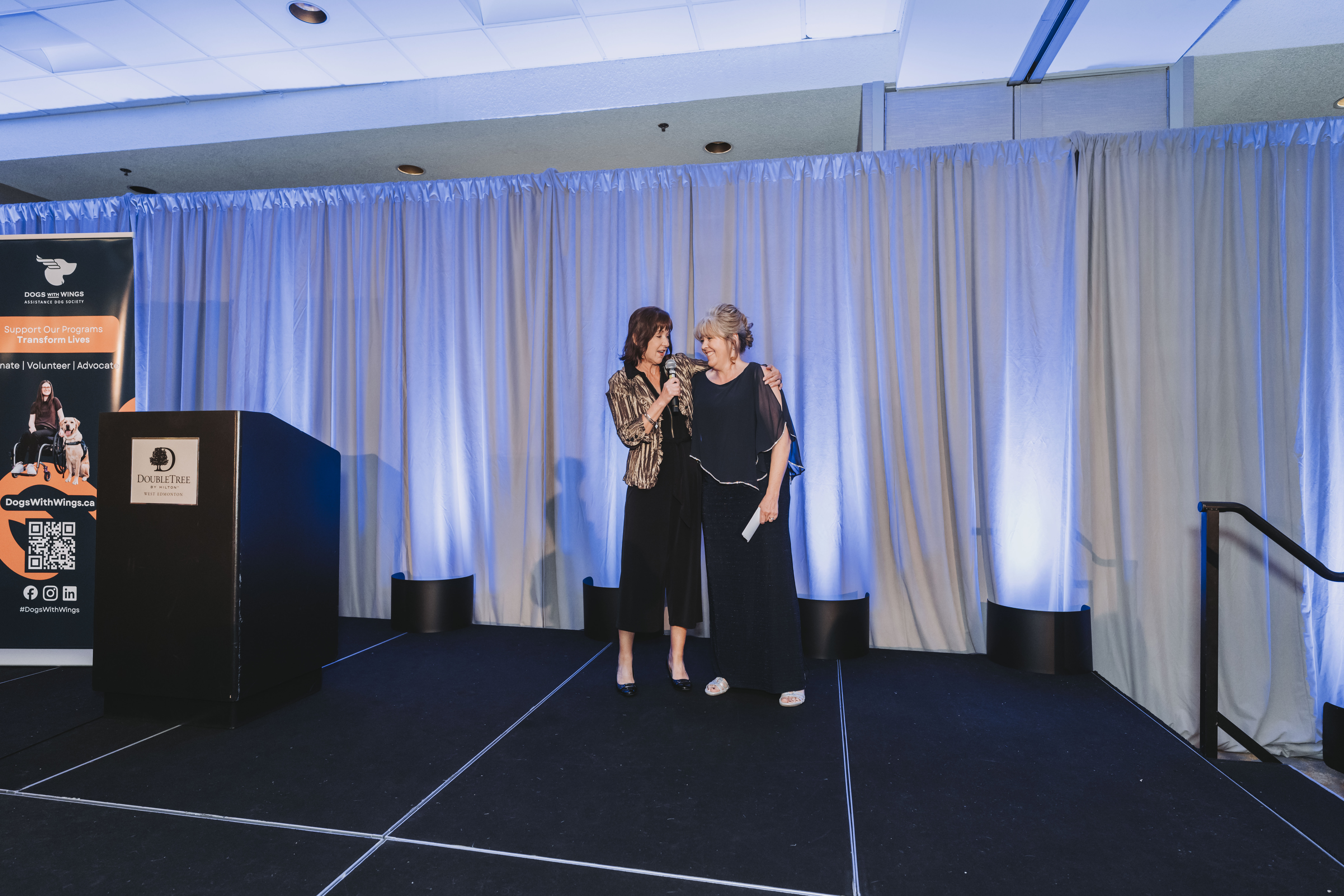Two guests speaking together on the gala stage