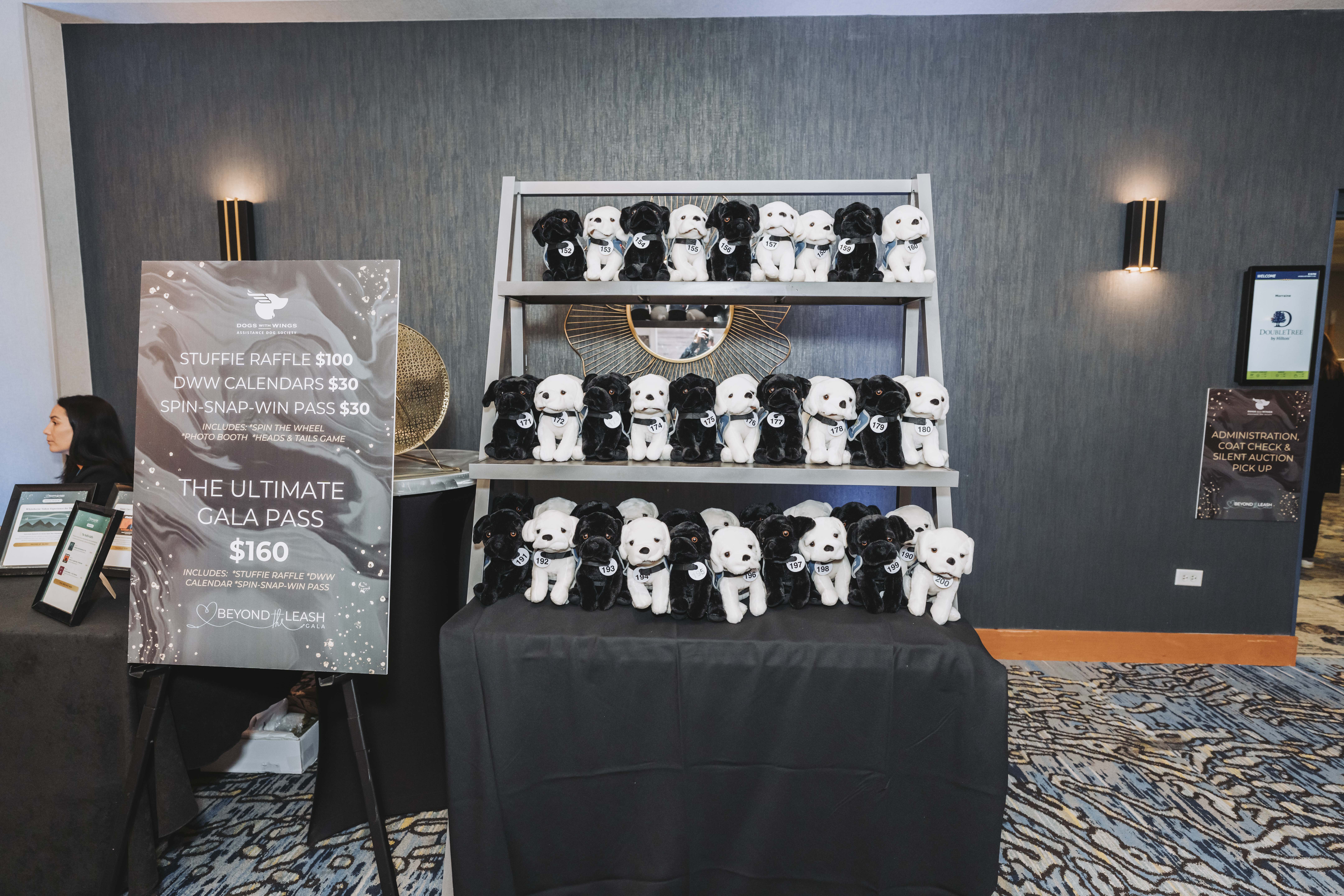 The stuffie raffle display and gala pass sign