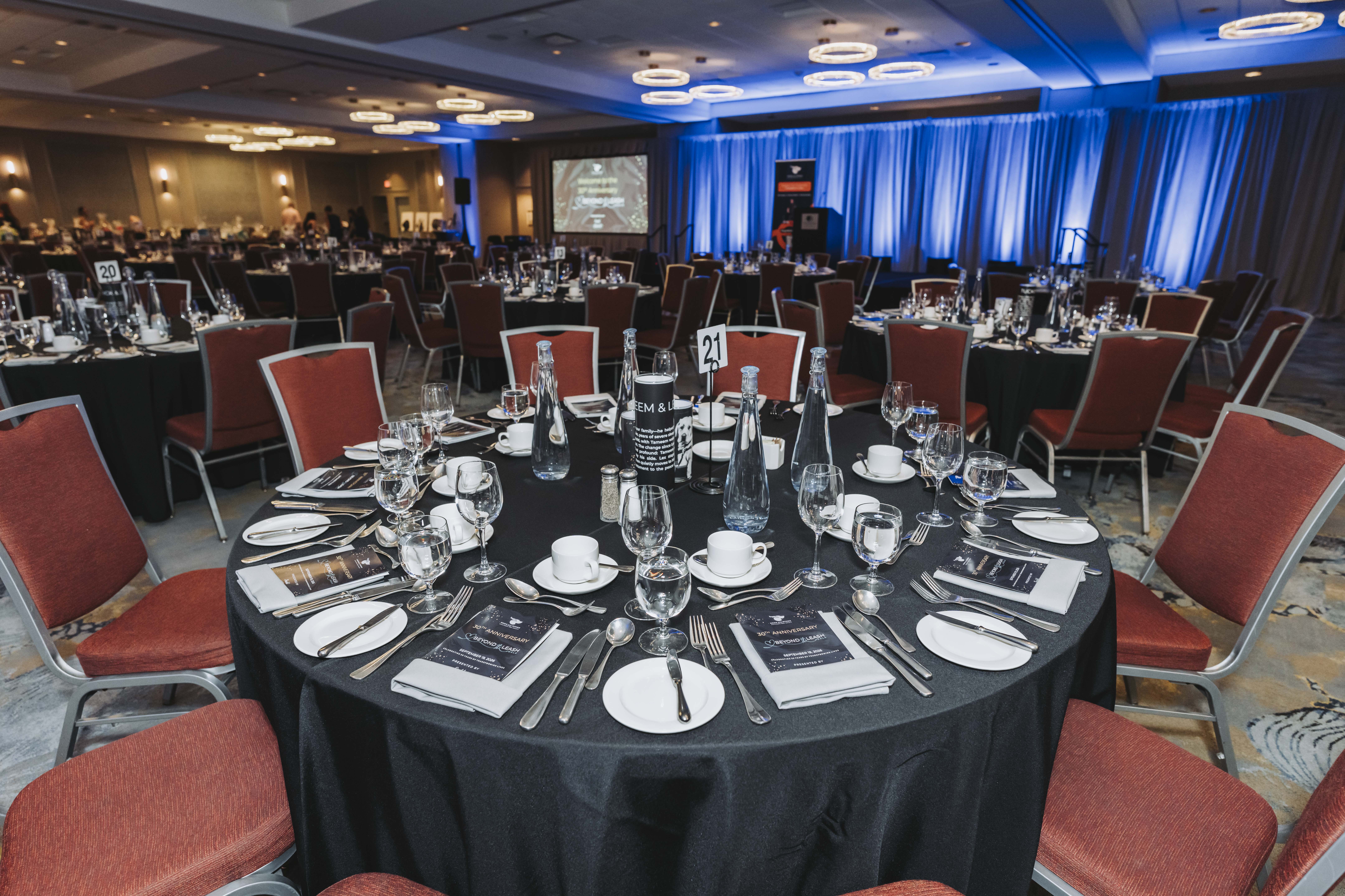 The ballroom set with round tables ready for the anniversary gala