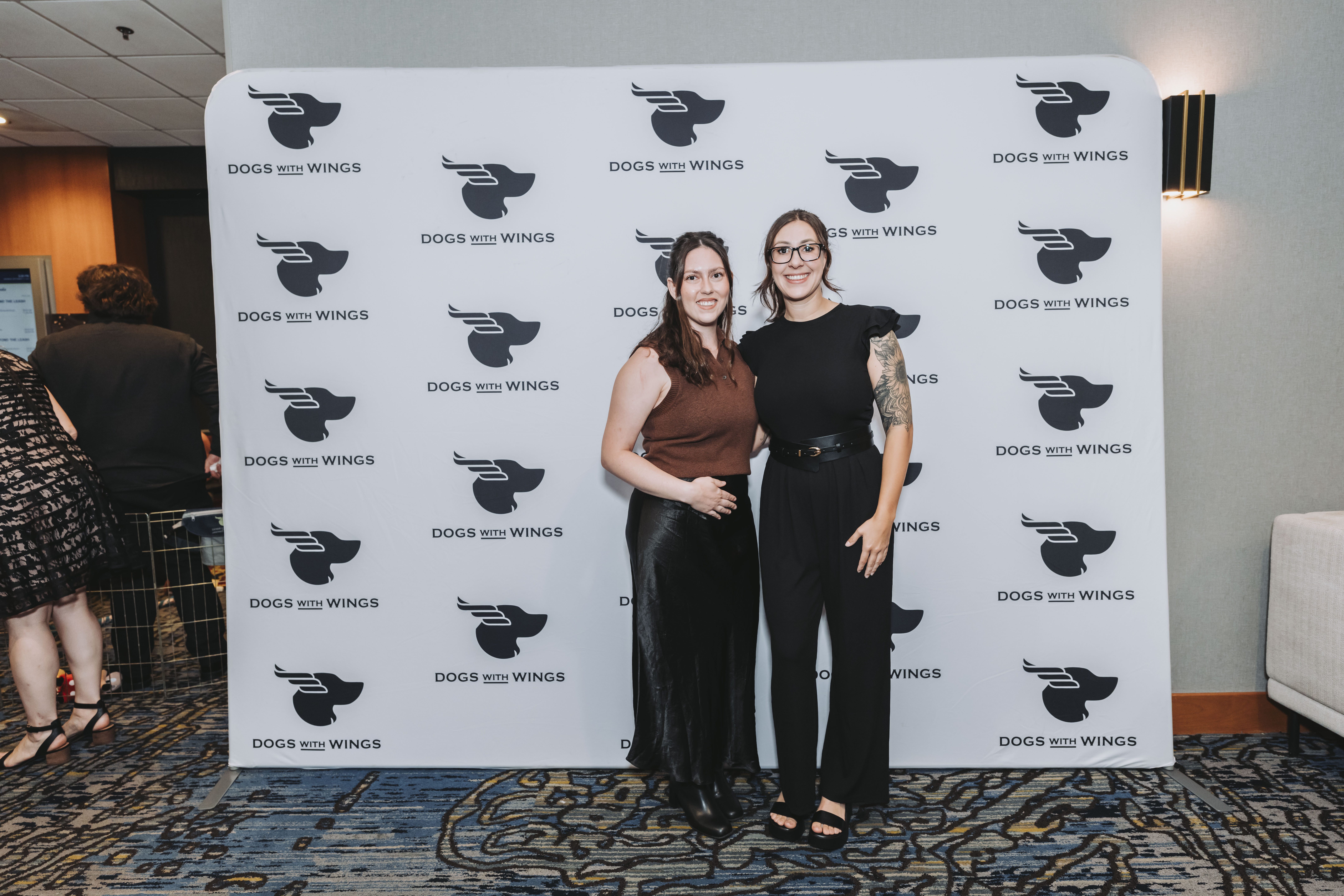 Two guests posing at the gala step-and-repeat