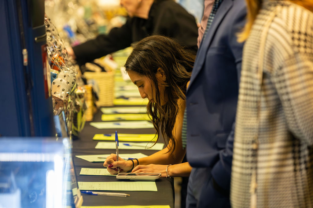 Gala 2025 guest bidding at silent auction