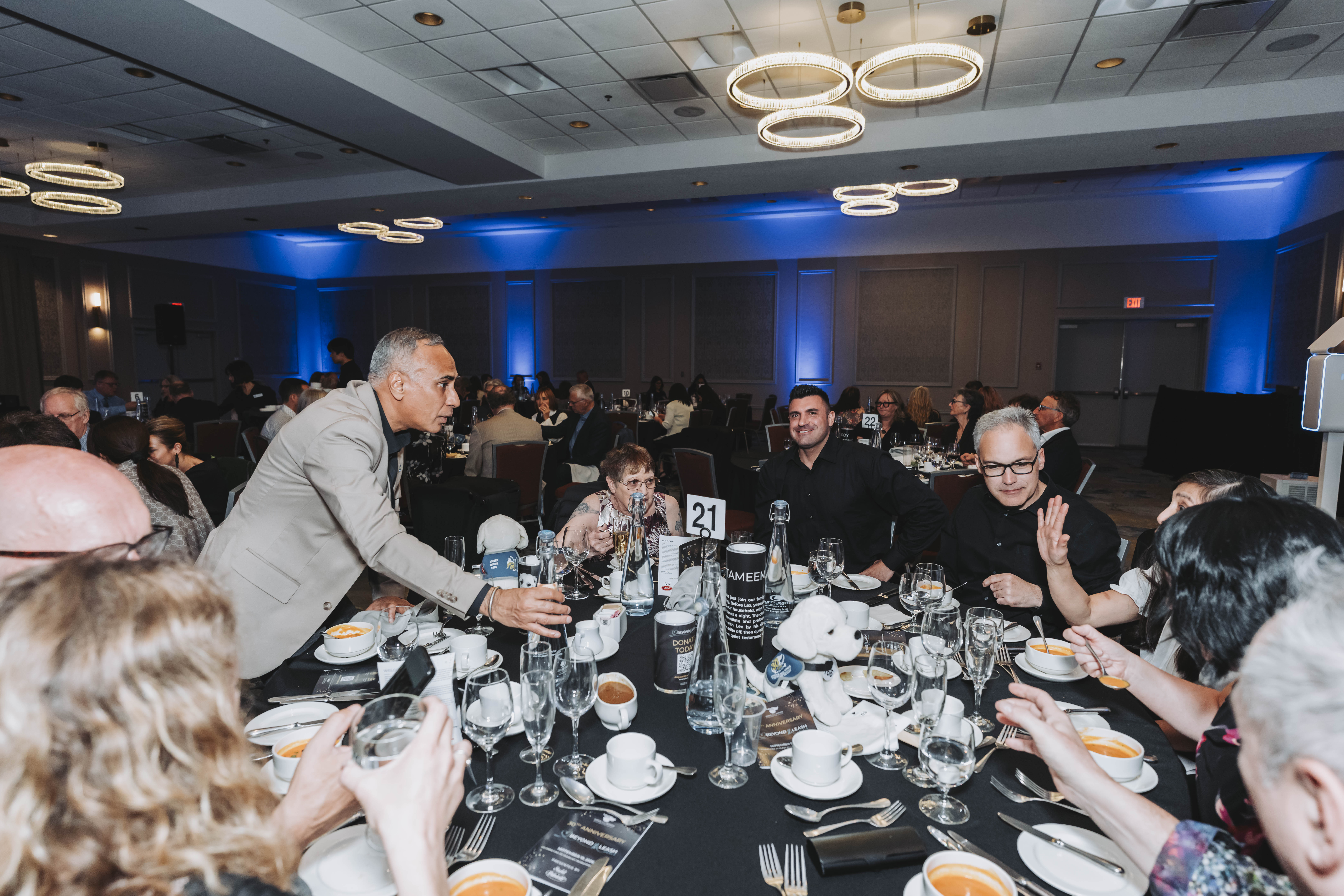 A guest addressing table 21 during the gala dinner