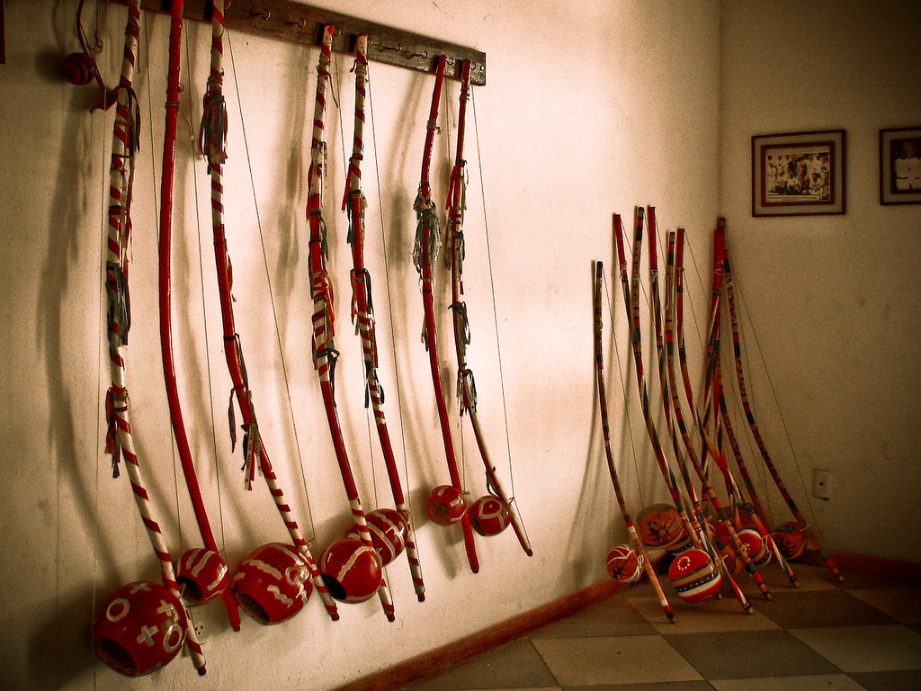 Capoeira instruments flat-lay on wooden floor