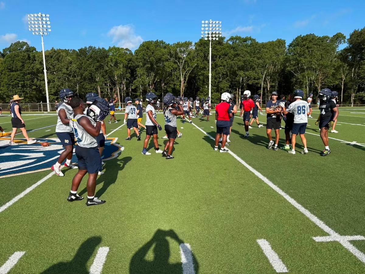 Coach walking with a youth football program during a community event