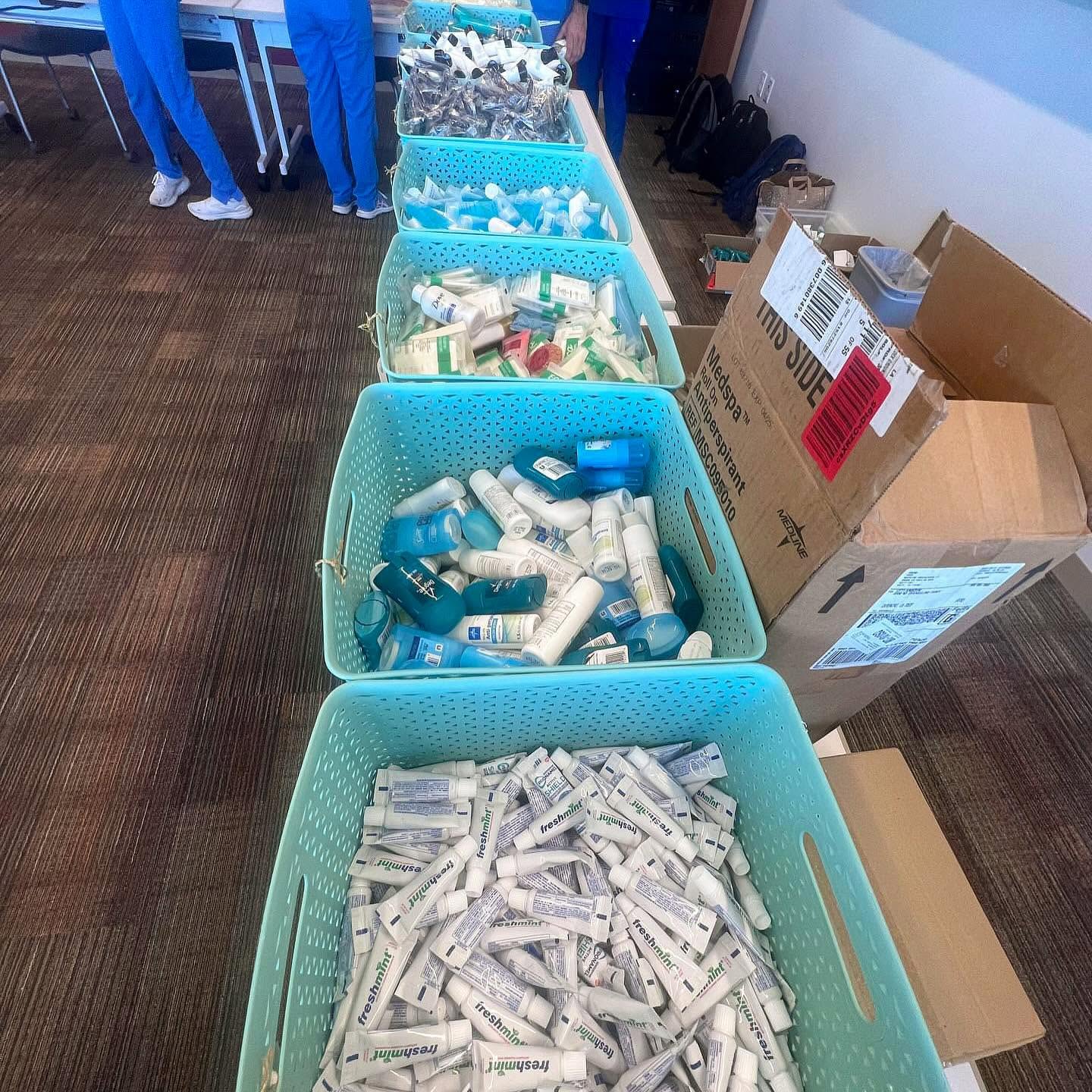 Personal-care products sorted into turquoise bins for FACE bag assembly