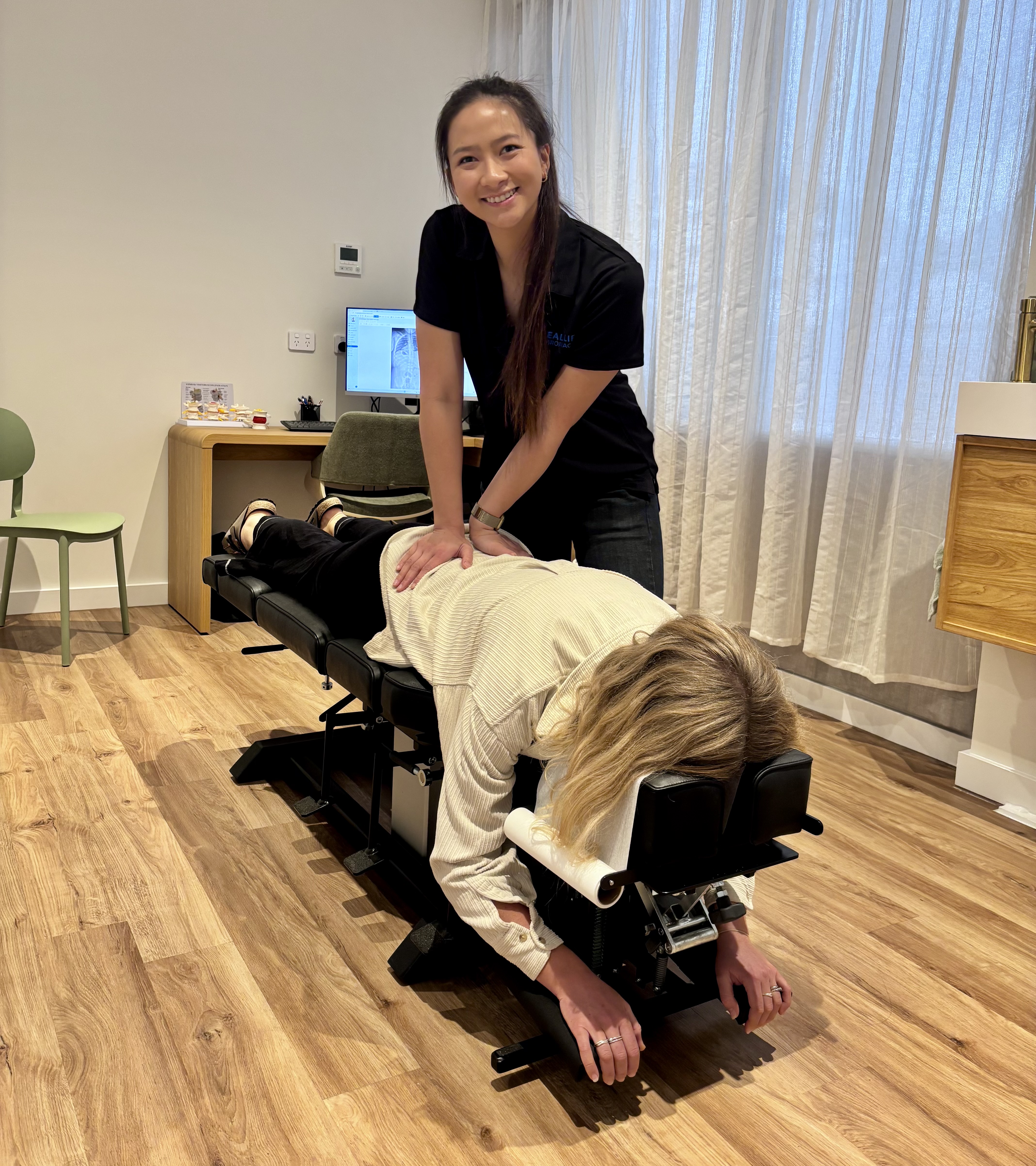 Dr Celina performing a spinal adjustment on a patient at Real Life Chiropractic Watagan Park, Cooranbong NSW