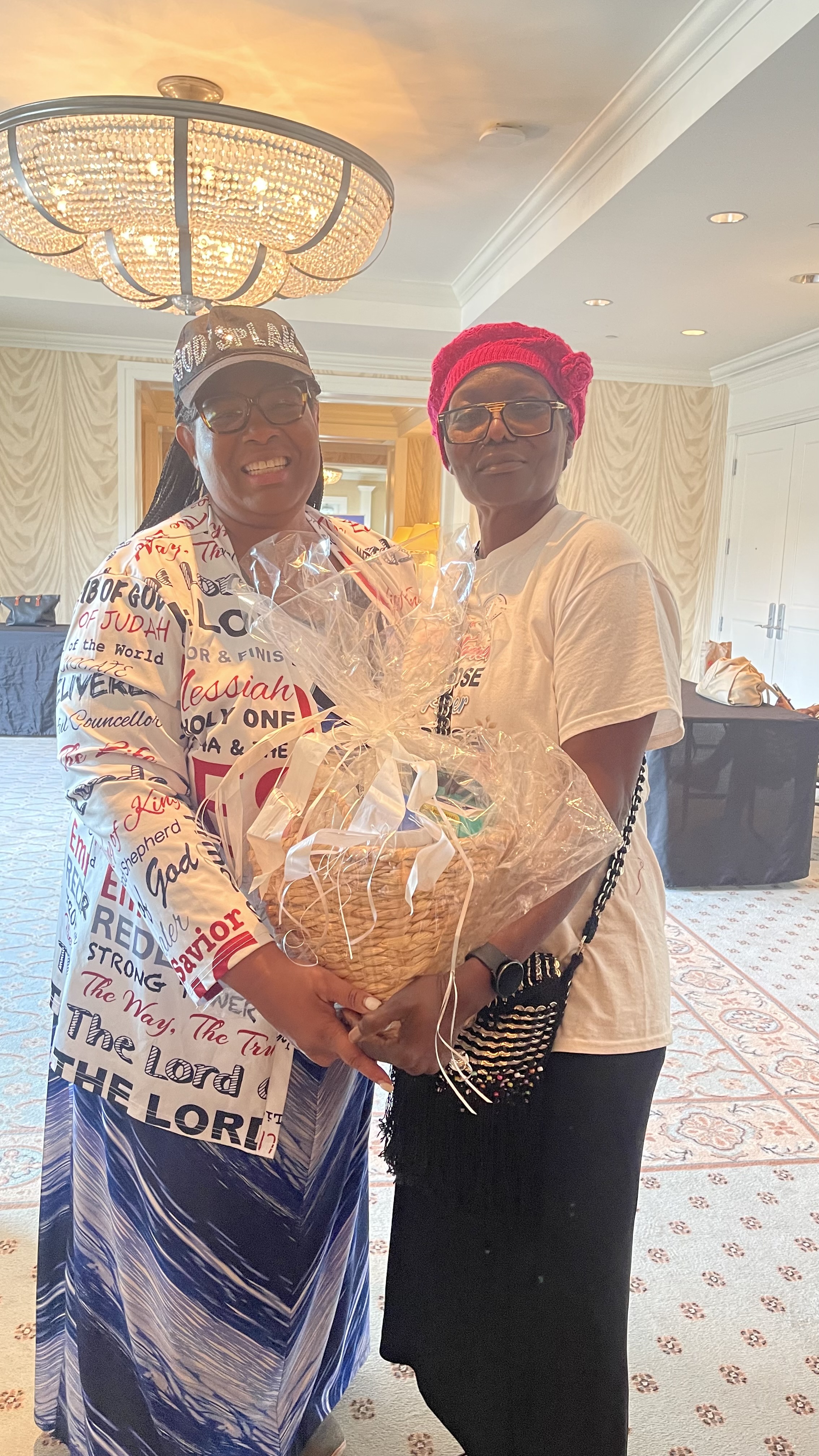 Sharon Small, honored as a Hidden Figure of Caregiving by TCCWFI, holding a gift basket at a community event