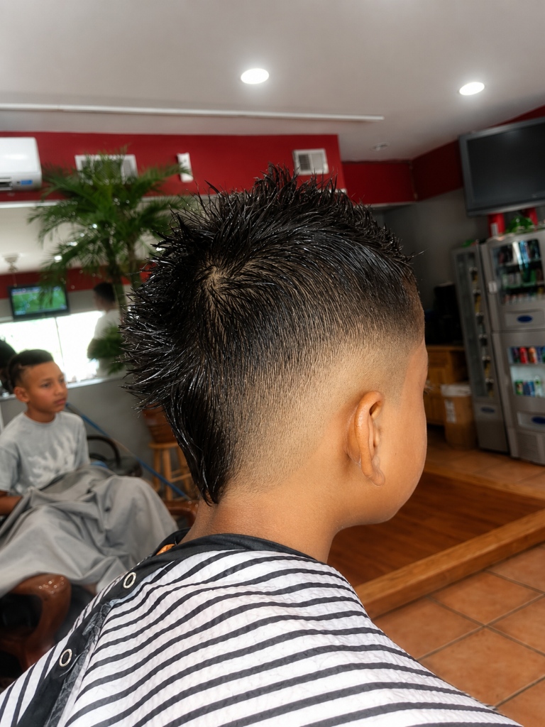 Young person with mohawk skin fade