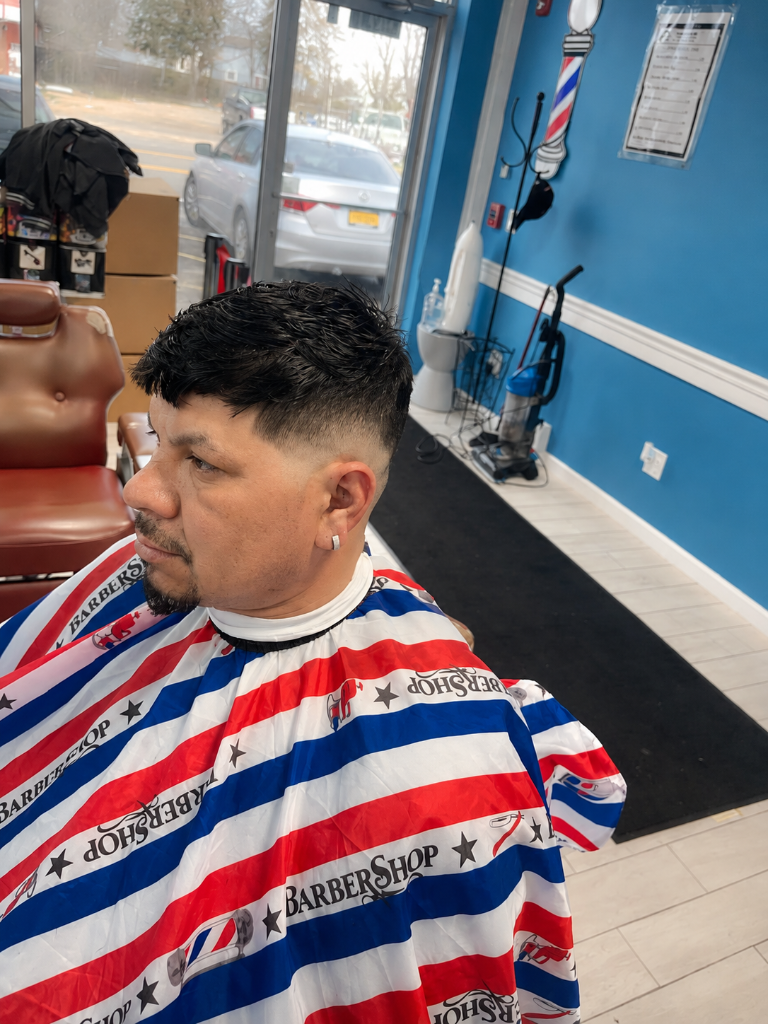 Client in barber chair with patriotic cape