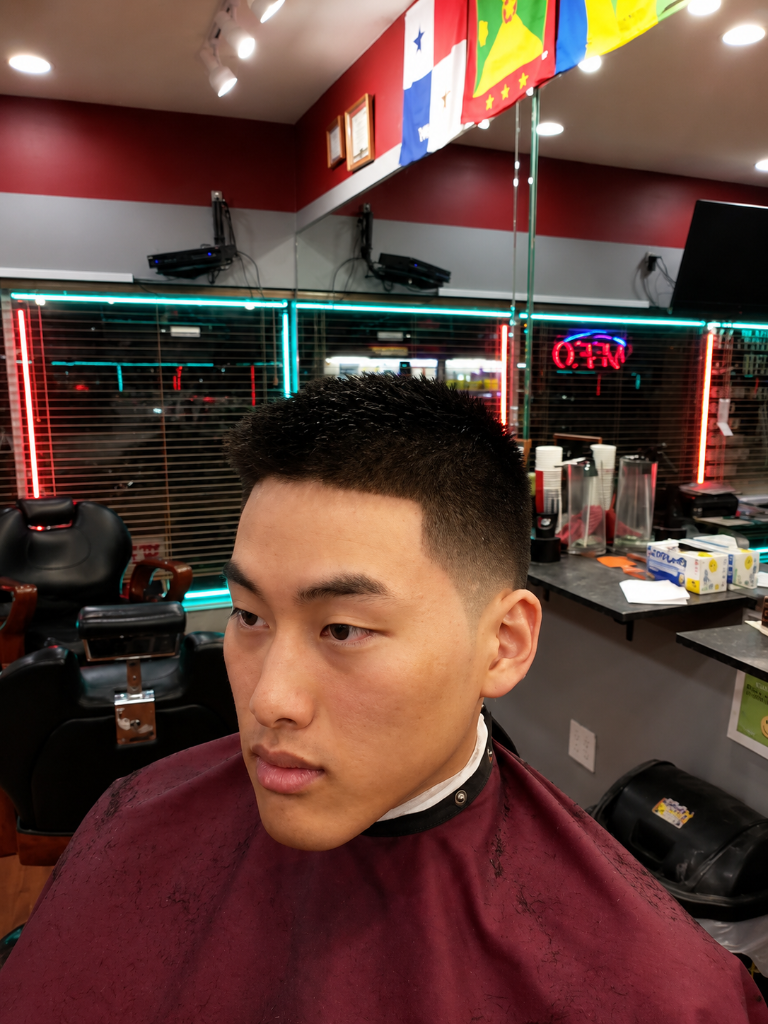Young man with fresh fade in front of mirror