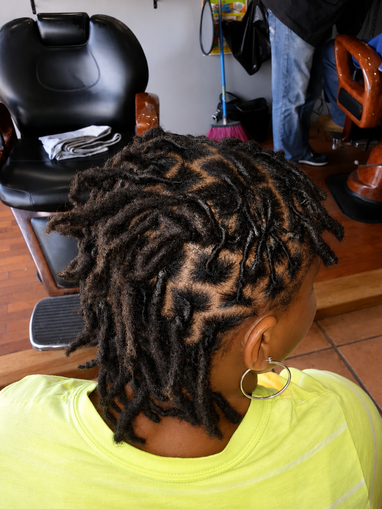 Person with locs in barber chair