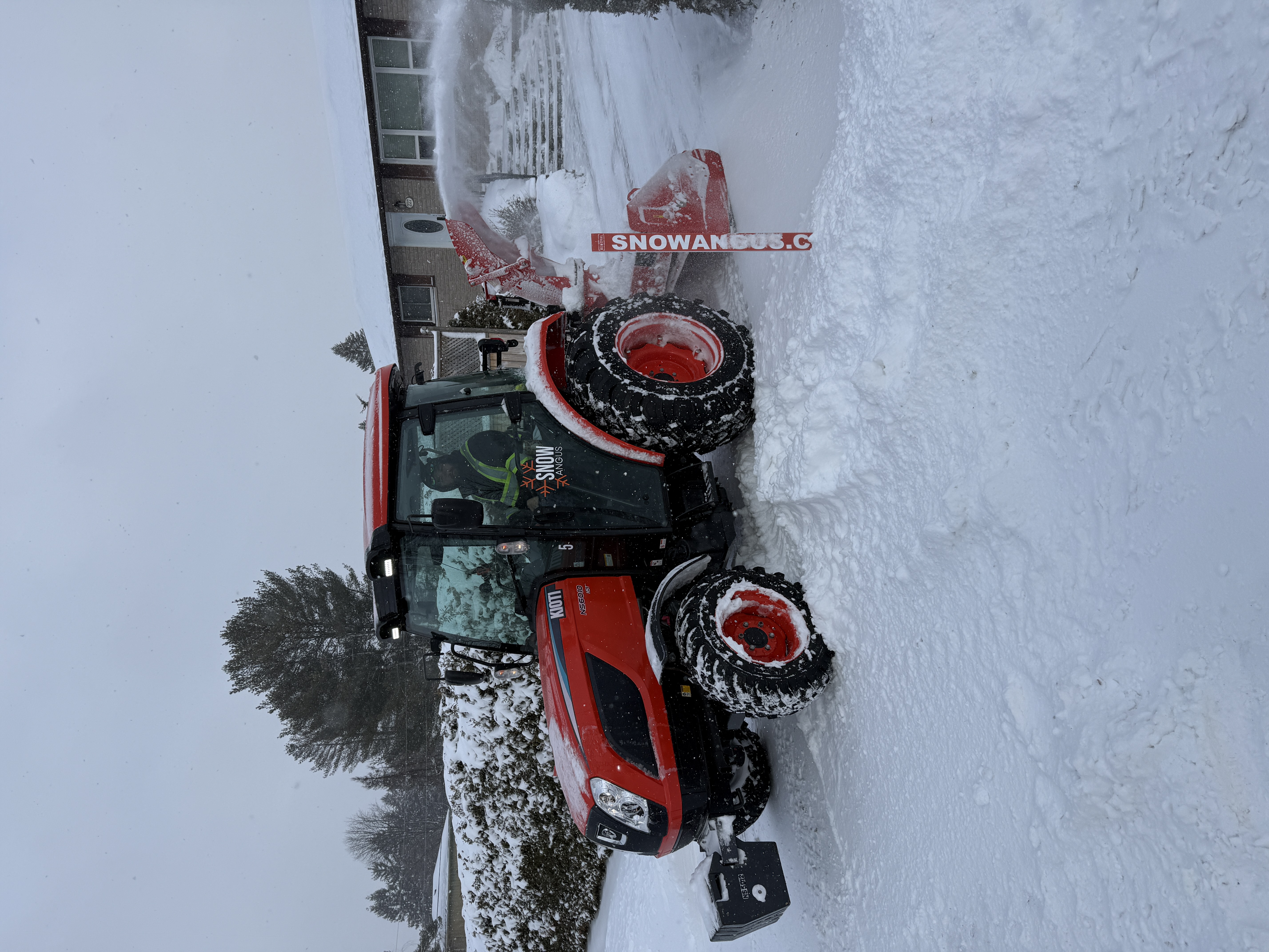 Snow Angus tractor clearing snow