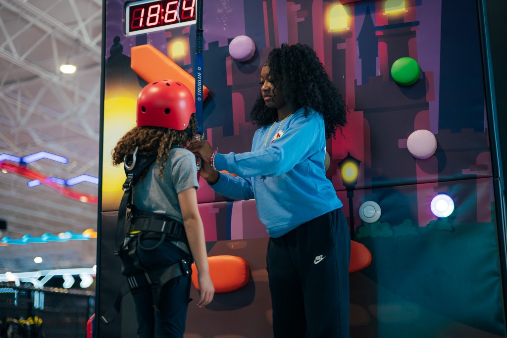 Rock climbing wall with safety harness at Lululand Adventure Park