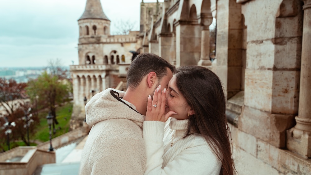 Marriage proposal photography Budapest — couple kissing at Fisherman's Bastion
