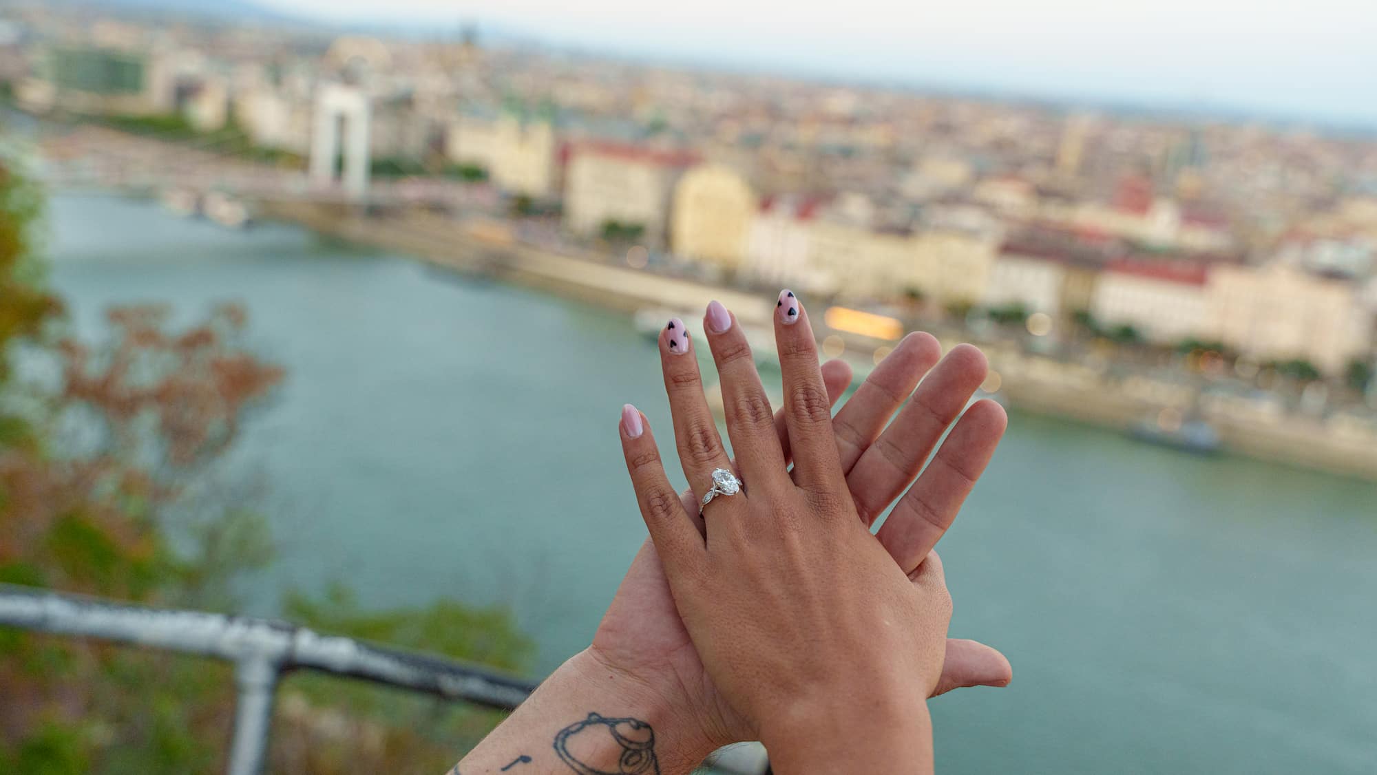 Engagement ring close-up Budapest — diamond ring with Danube cityscape at Citadella
