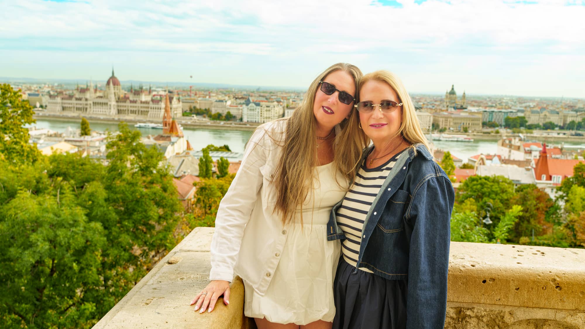 Family photoshoot Budapest — two women at Fishermans Bastion with Parliament view