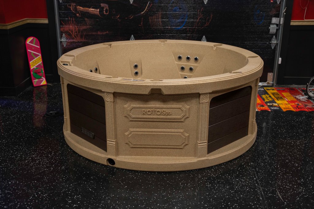 Roto Spa SE round hot tub with granite-look shell and dark brown panels