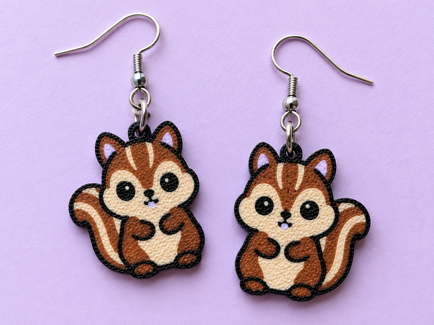 Chipmunk earrings with brown and tan bodies, black outlines and lavender accents