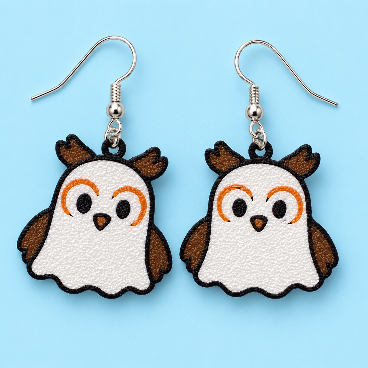 Hootin' & Hauntin' owl ghost earrings — white and brown 3D-printed earrings with orange brows and black outlines