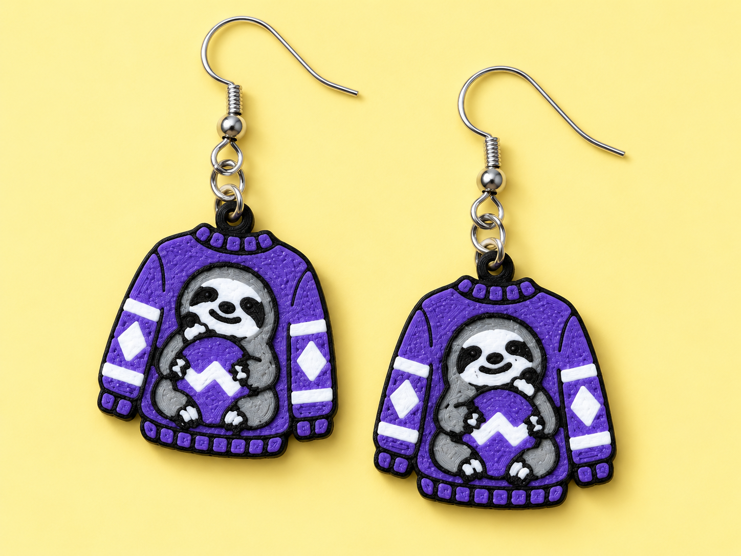Purple Christmas sweater earrings with a grey sloth holding a white-frosted cookie