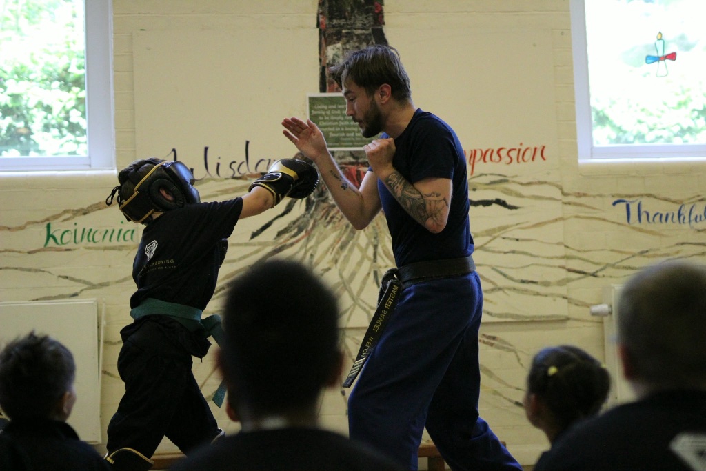 Master Sam Welch coaching on the mats