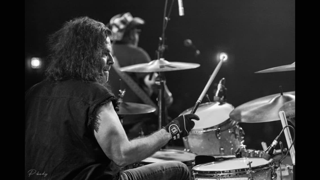 Nick playing the drums during a live performance
