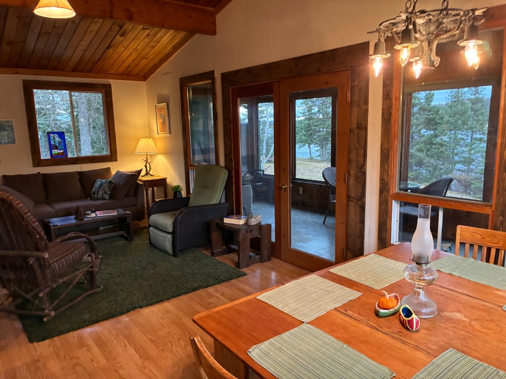Open living and dining area inside the lodge with lake views