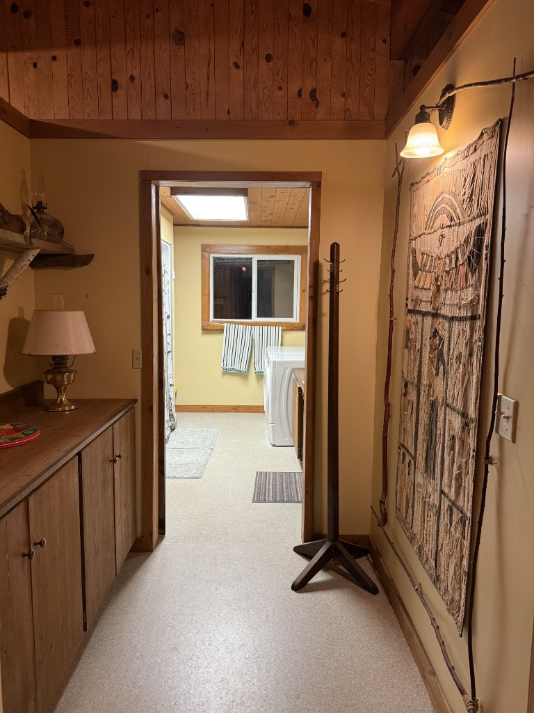 Cottage bathroom hallway leading to the laundry area