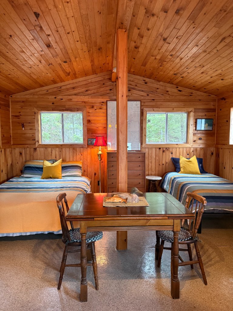 Bunky bedroom with two beds and a lake-view porch