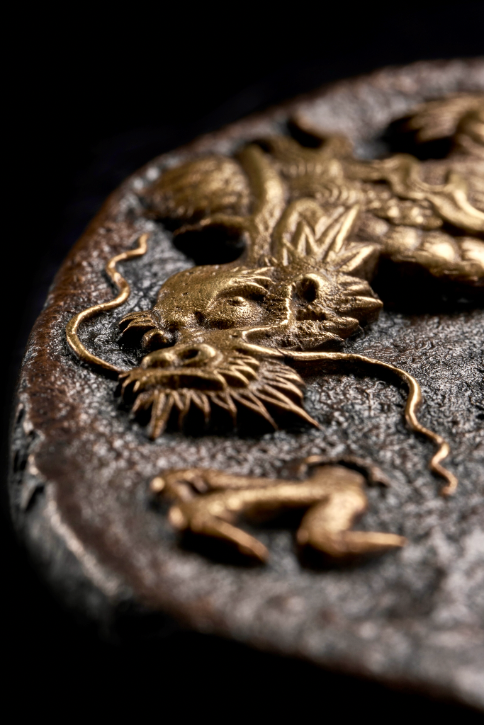 Close-up of a Japanese tsuba featuring a golden dragon