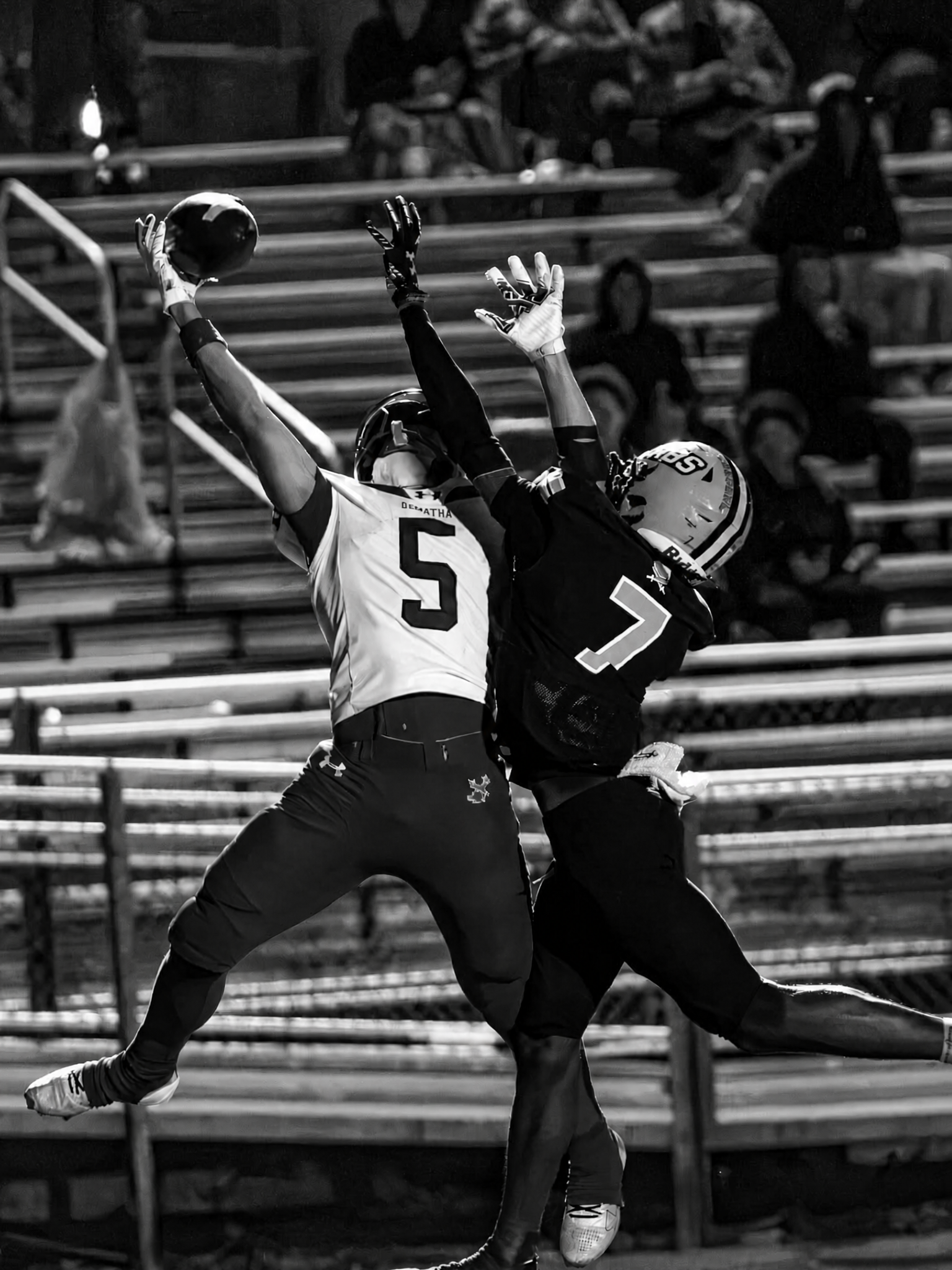 Austin Barber leaping to make a contested catch for DeMatha