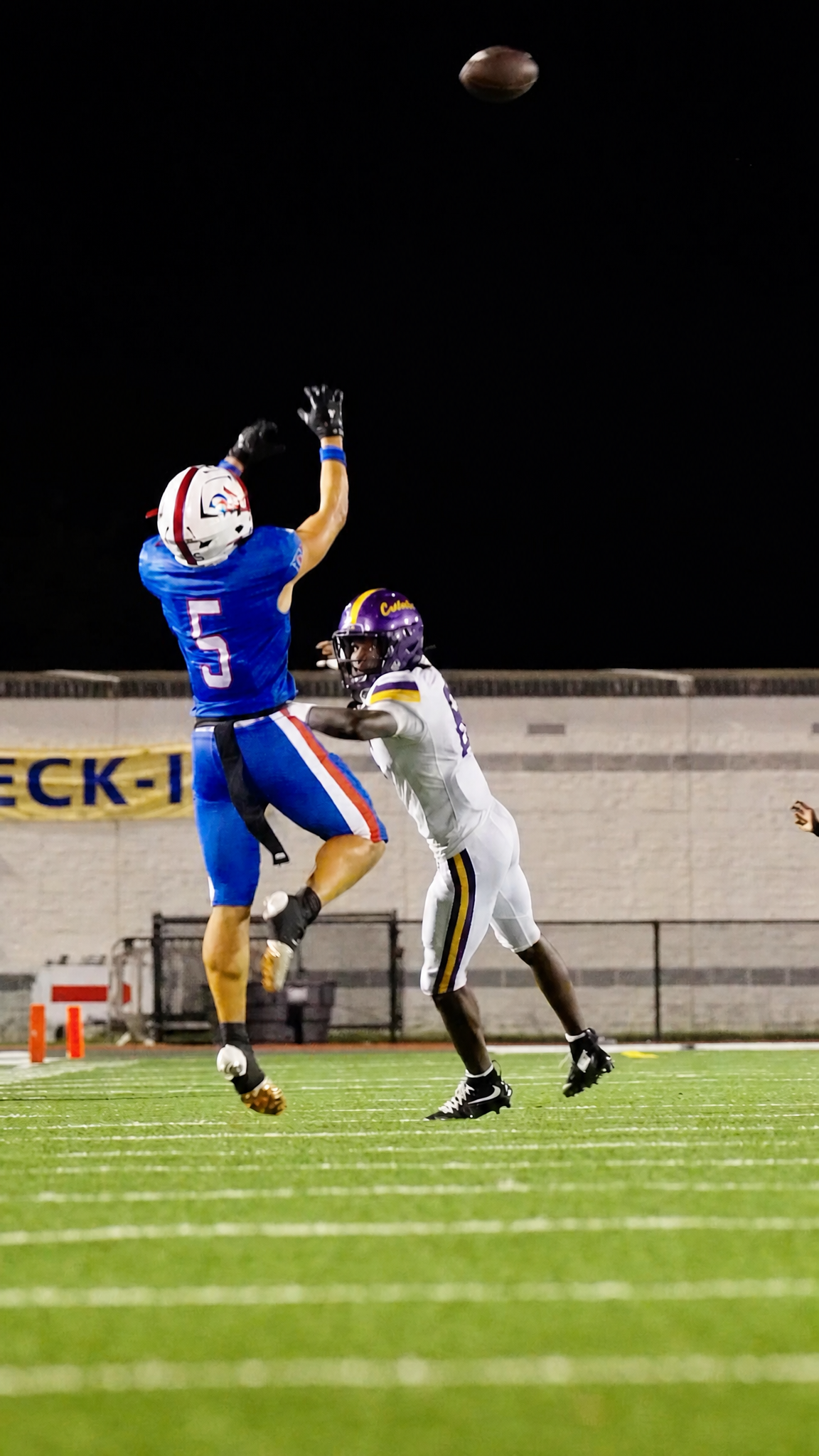 Austin Barber high-pointing a deep ball under the lights