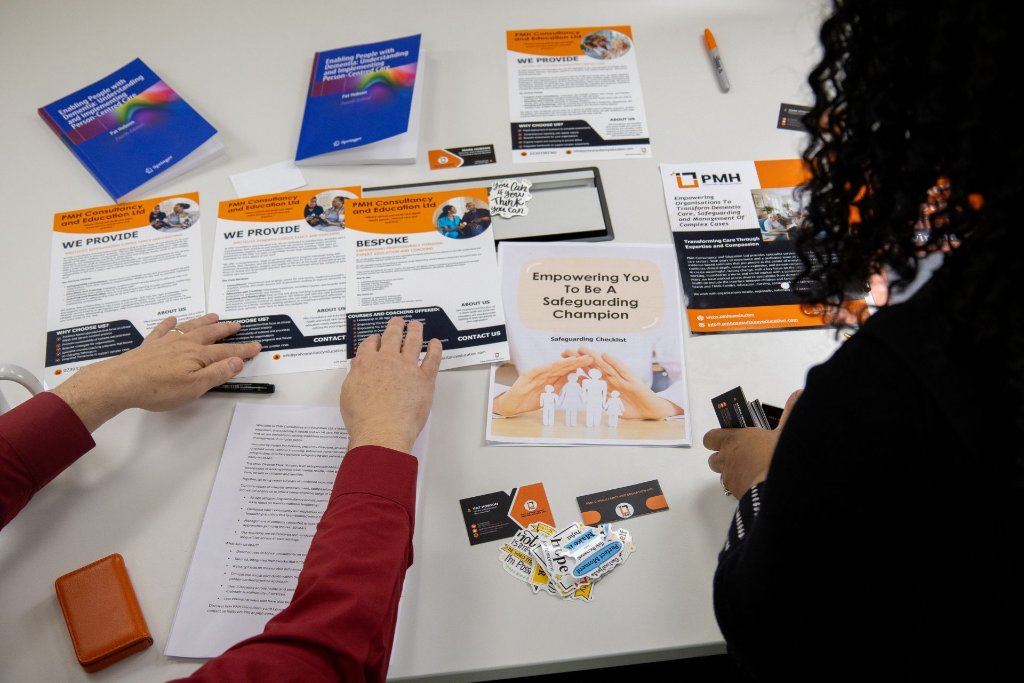 PMH consultancy resources and safeguarding materials spread across a professional workspace during a consultancy session
