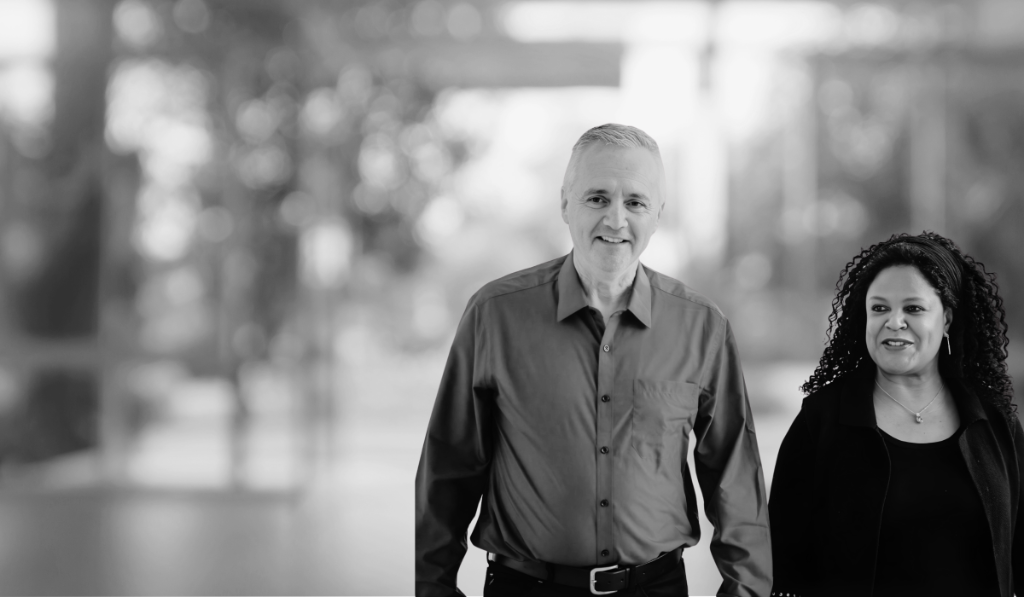 Pat and Mark Hobson, Directors of PMH Consultancy and Education, black and white portrait