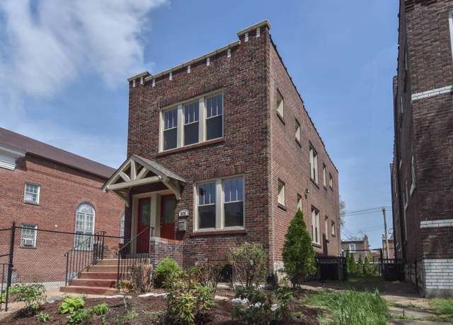 Two-story red brick four-flat building with gabled porch hood in Tower Grove, St. Louis, Missouri