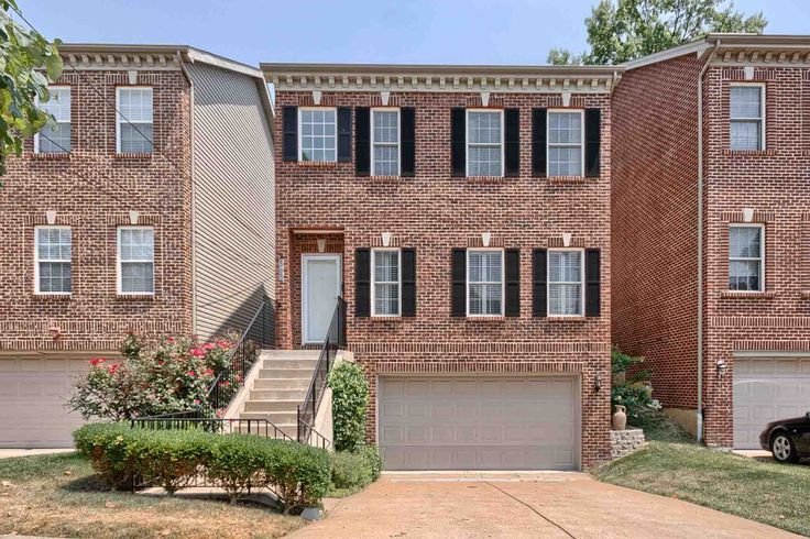 Three-story red brick bungalow with white mortar and stone lintels in Dogtown neighborhood, St. Louis, Missouri