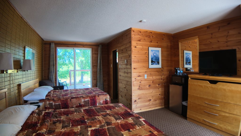 Deluxe room interior with two double beds and a private deck