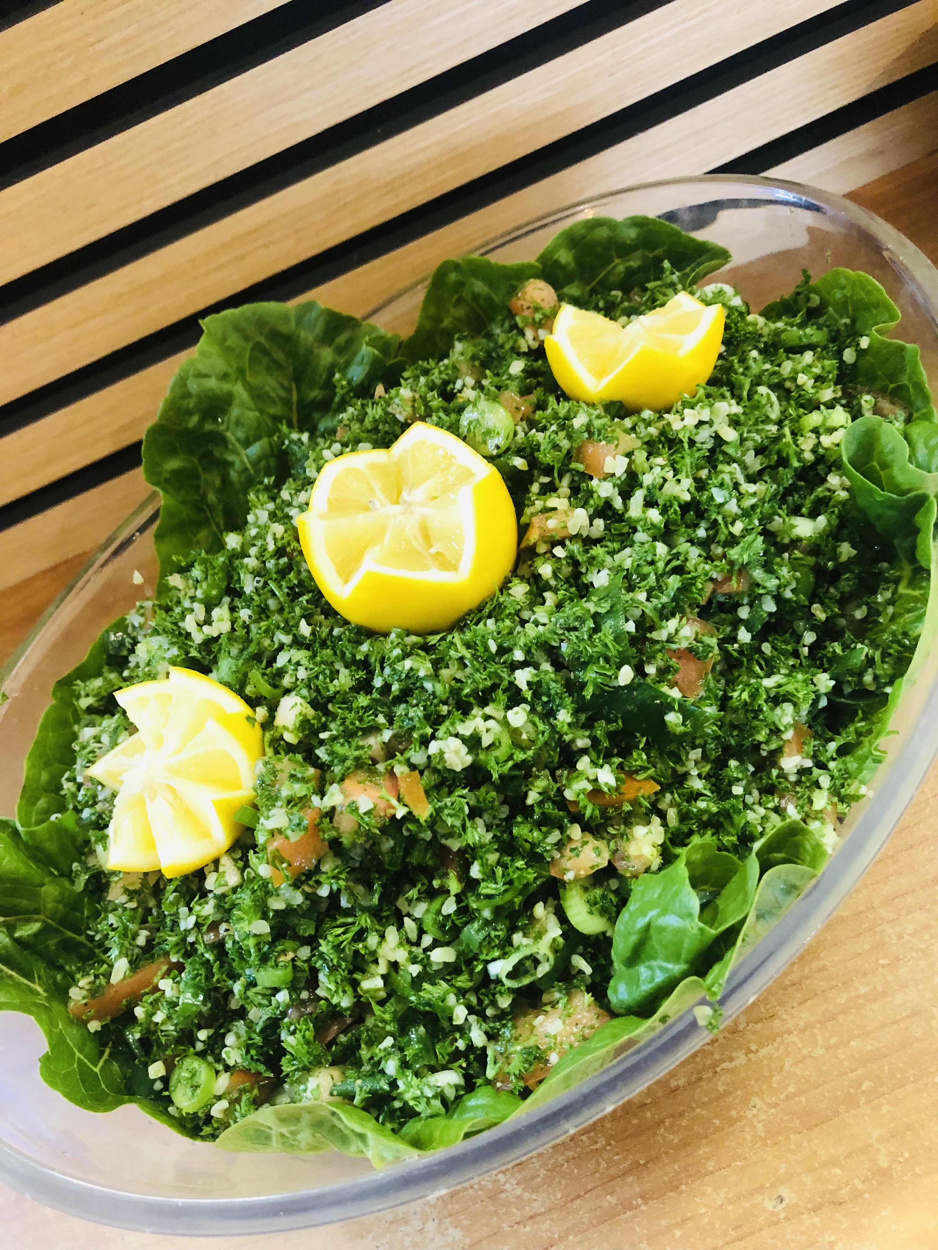Tabbouleh salad with parsley, bulgur and lemon wedges